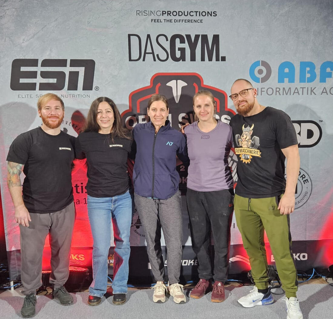 Powerlifting coach celebrating with athletes after a successful meet, highlighting team spirit, strength achievements, and results-driven coaching in competitive powerlifting.